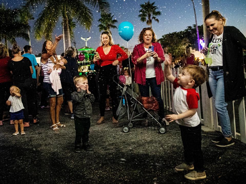 Fake snow falls from the sky during the Cape Coral  Holiday Festival of Lights in downtown Cape Coral on Saturday, Dec. 4, 2021. The packed event featured a LCEC tree lighting, a sledding hill, dance recitals, food vendors and more. 