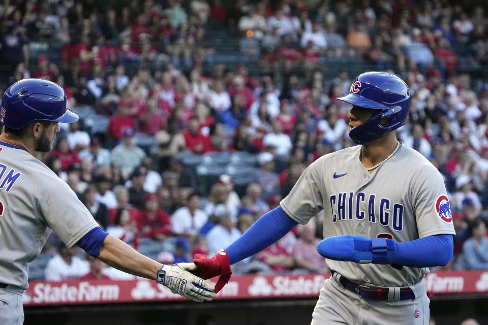 Chicago Cubs' Miguel Amaya, right, is congratulated by Patrick Wisdom after scoring on a double by Trey Mancini during the second inning of a baseball game against the Los Angeles Angels Thursday, June 8, 2023, in Anaheim, Calif. (AP Photo/Mark J. Terrill)