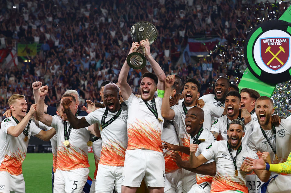 West Ham captain Declan Rice and teammates celebrate with the trophy after winning the Europa Conference League.