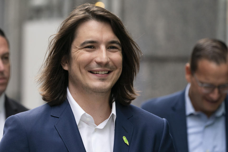 Vladimir Tenev, CEO and Co-Founder of Robinhood, walks in New York's Times Square following his company's IPO, Thursday, July 29, 2021. Robinhood is selling its own stock on Wall Street, the very place the online brokerage has rattled with its stated goal of democratizing finance. Through its app, Robinhood has introduced millions to investing and reshaped the brokerage industry, all while racking up a long list of controversies in less than eight years. (AP Photo/Mark Lennihan)