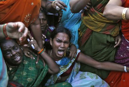 Supporters of J. Jayalalithaa, chief minister of India's Tamil Nadu state and chief of the AIADMK party, shout slogans during a protest against the court verdict in Chennai September 27, 2014. REUTERS/Babu