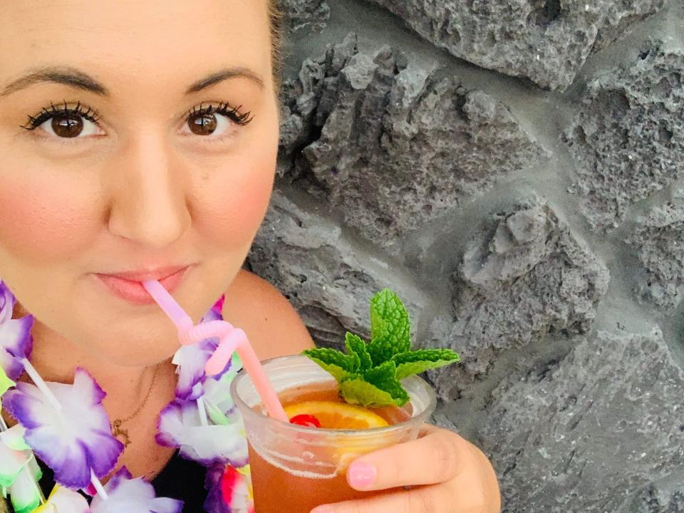 carly drinking a cocktail at polynesian resort