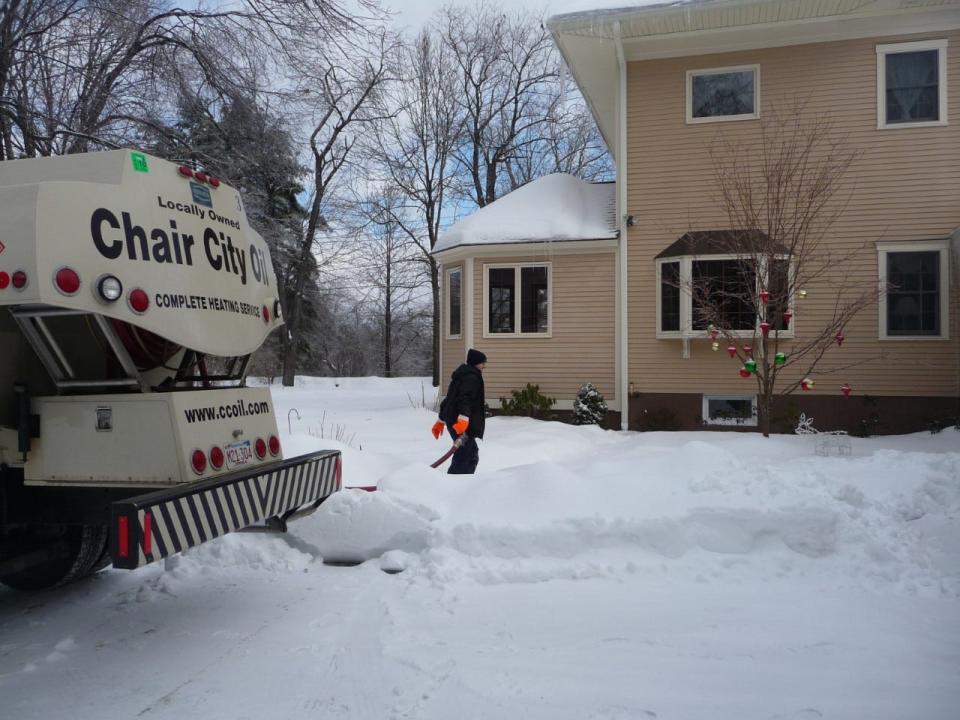 An employee of Chair City Oil in Gardner, Massachusetts, makes an oil delivery during the wintertime.