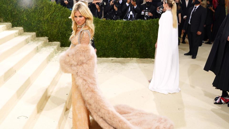 Her shimmering mixed-metal gown with oversized blush fur coat