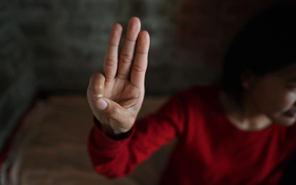 The three-finger salute has become a symbol of resistance  - SAJJAD HUSSAIN/AFP via Getty Images