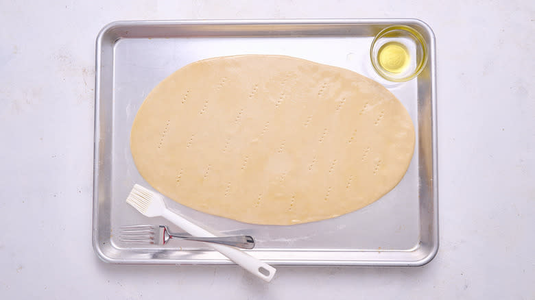 brushing oil on flatbread crust