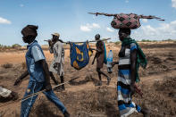 <p>Relatives escort a Dinka woman affected by cholera to a temporary hospital in Mingkaman, a camp for the Internally Displaced Persons (IDPs) on April 26, 2017, in the Eastern Lakes States, South Sudan. Many of the displaced people have crosssed the Nile to reach the Mingkaman camp from neighboring states.(Photo: Fabio Bucciarelli/AFP/Getty Images) </p>