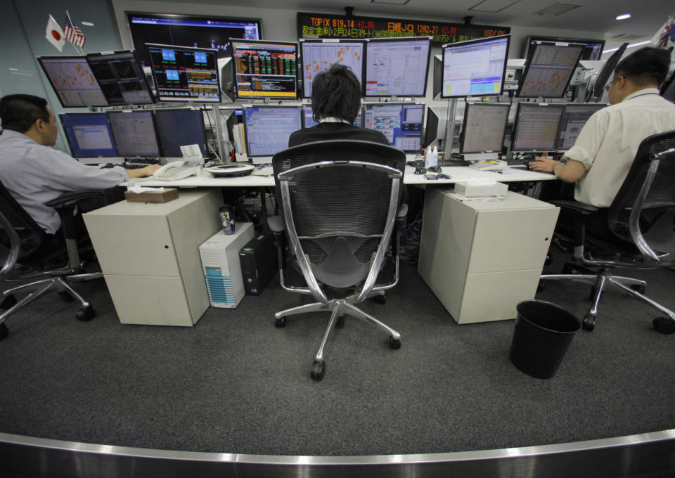 Money traders work at a foreign exchange firm in Tokyo Wednesday, Feb. 22, 2012. The U.S. dollar rose to the 80-yen mark Wednesday for the first time since Aug. 4 in midday Tokyo time. (AP Photo/Itsuo Inouye)