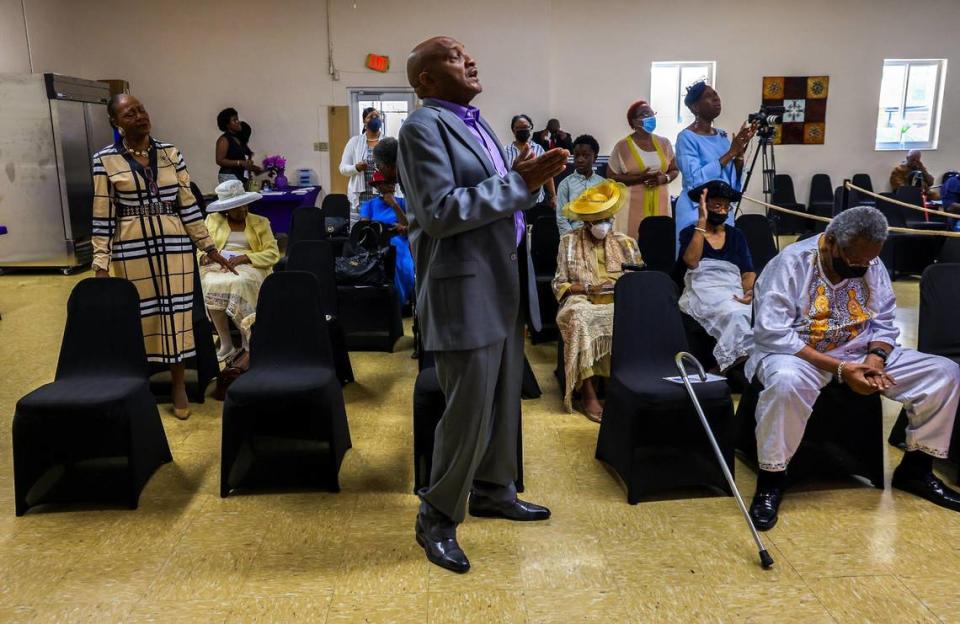 Johnny Peoples, a member of St. John Institutional Missionary Baptist Church in Overtown for 37 years, stands in prayer during Sunday service in the church’s fellowship hall on July 23, 2023.