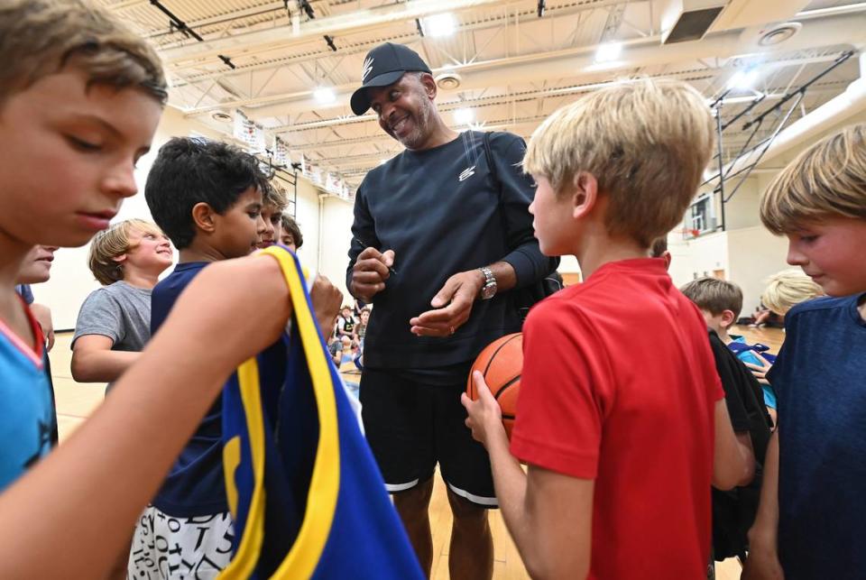 Former Charlotte Hornets forward Dell Curry, center, jokes with participants of his basketball camp at the Jewish Community Center in Charlotte, NC on Monday, August 7, 2023. Curry is a color commentator for the Charlotte Hornets. He is also the father of NBA stars Steph and Seth Curry.