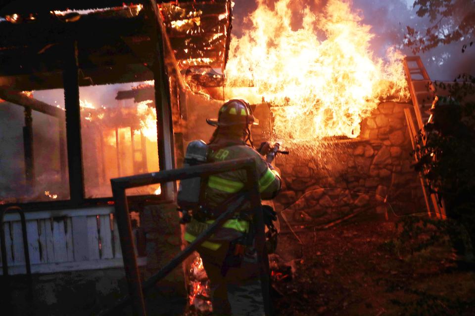 Firefighters from several Putnam County departments assist Lake Carmel firefighters in battling a house fire during a thunderstorm on Church Hill Road in the Lake Carmel section of Kent. May. 22, 2022. The fire caused extensive damage to the home.