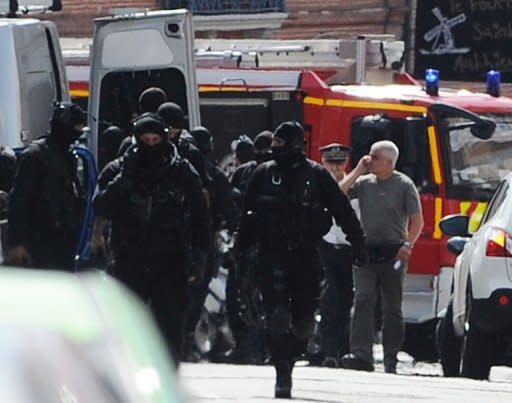 French rapid-intervention GIPN police units leave the area after police stormed a bank in Toulouse, arresting a gunman with psychiatric problems who claimed to be an Al-Qaeda militant. Two hostages were freed after a seven-hour siege