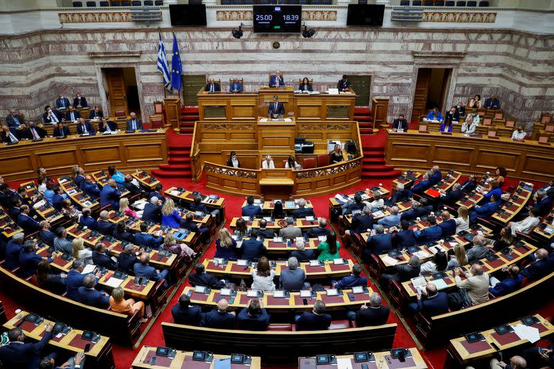 FILE PHOTO: Greek PM Mitsotakis addresses lawmakers during a parliamentary on a wiretapping case in Athens