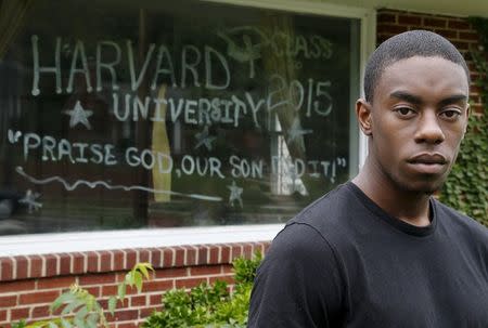 Fadhal Moore, a 2015 graduate of Harvard University, is celebrated by a front window painted with his accomplishment at his family's home in Washington June 3, 2015. REUTERS/Jonathan Ernst