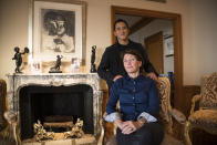 FILE - Marina Picasso, sitting, granddaughter of artist Pablo Picasso, and her son Florian Picasso pose for a photo during an interview with the Associated Press in Cologny near in Geneva, Switzerland, Tuesday, Jan. 25, 2022. The pair told The Associated Press that they planned to sell 1,010 digital art pieces of one of his ceramic works that has never before seen publicly but a lawyer for the late artist says no sale of digital Picasso art has not been permitted and no digital Picasso artwork would be sold. (AP Photo/Boris Heger, File)