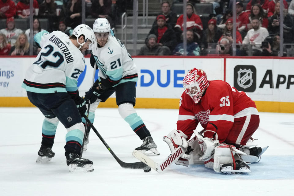 Detroit Red Wings goaltender Ville Husso (35) stops a Seattle Kraken right wing Oliver Bjorkstrand (22) shot in the third period of an NHL hockey game Thursday, March 2, 2023, in Detroit. (AP Photo/Paul Sancya)