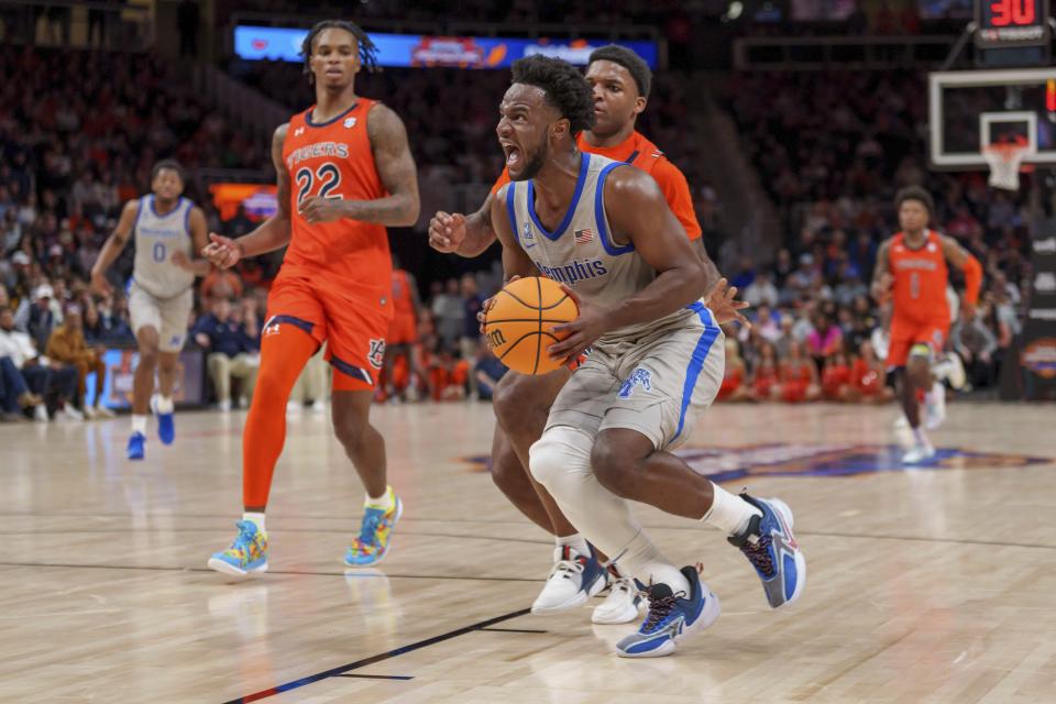 Memphis guard Alex Lomax, front right, makes a play against Auburn guard Allen Flanigan (22) during the second half of an NCAA college basketball game on Saturday, Dec. 10, 2022, in Atlanta. (AP Photo/Erik Rank)