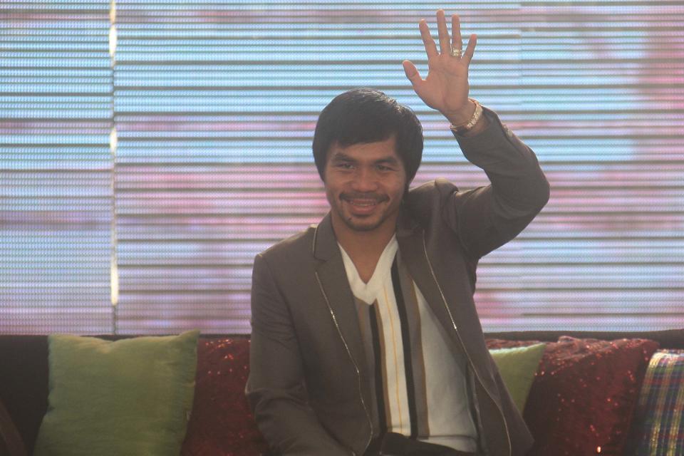 Manny Pacquiao waves at his fans during a homecoming event prepared by GMA Network (George Calvelo/NPPA Images)