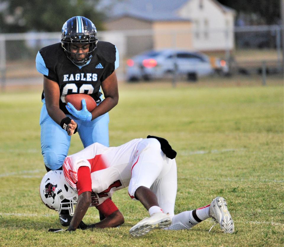 Aspermont's Donovan Miller (7) upends TLCA-Abilene's Zaidryn Moreno-Nobles (60) on a run play in the first quarter. Aspermont beat the Eagles 45-0 in a nondistrict game stopped at halftime on the mercy rule at Curly Hayes Field. The Eagles make the jump to 11-man this season.