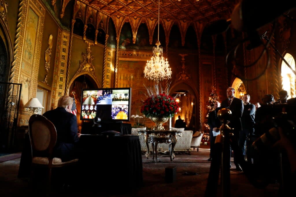 FILE – Then-President Donald Trump listens during a Christmas Eve video teleconference with members of the military at his Mar-a-Lago estate in Palm Beach, Fla., Dec. 24, 2019. Trump says the FBI is conducting a search of his Mar-a-Lago estate. Spokespeople for the FBI and the Justice Department did not return messages seeking comment Monday, Aug. 8, 2022.(AP Photo/Andrew Harnik)