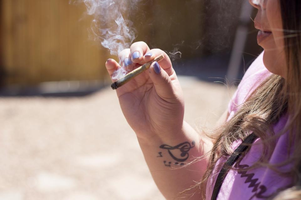 Sol Cannabis was the first cannabis consumption lounge in the state of New Mexico. Several patrons smoke outside on the patio on 4/20 – April 20, 2022.