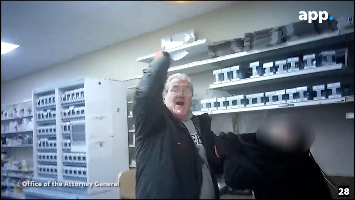 James Sutton is seen in police body camera footage raising a knife in one hand while holding a man hostage with the other at Keansburg Pharmacy on Jan. 6, 2022 in Keansburg, N.J.