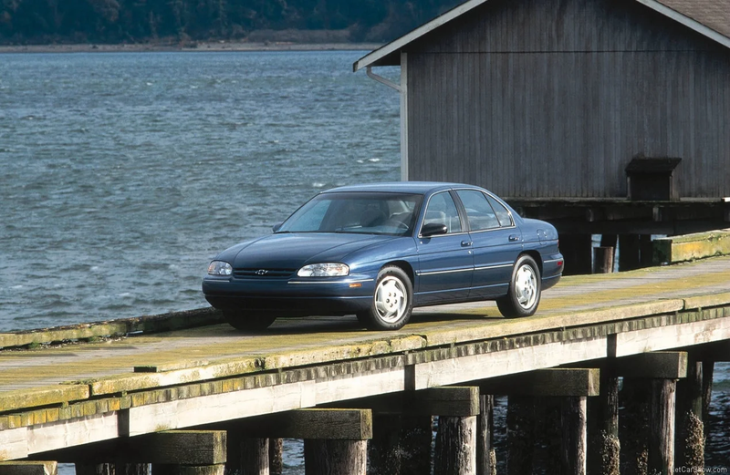 A blue Chevy Lumina parked on a pier