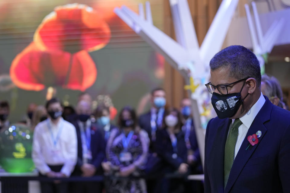 Alok Sharma President of the COP26 summit observes a moments silence to mark Armistice Day at the COP26 U.N. Climate Summit in Glasgow, Scotland, Thursday, Nov. 11, 2021. (AP Photo/Alastair Grant)