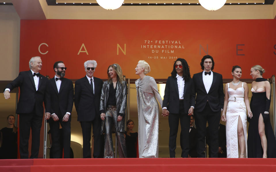 FILE - In this May 14, 2019 file photo, actors Chloe Sevigny, from right, Selena Gomez, Adam Driver, Luka Sabbat, Tilda Swinton, Sara Driver, director Jim Jarmusch, and actor Bill Murray, left, pose for photographers upon arrival at the opening ceremony and the premiere of the film "The Dead Don't Die" at the 72nd international film festival, in Cannes, southern France. Murray and Jarmusch have made three films together, starting with the 2003 black-and-white vignette anthology “Coffee and Cigarettes” and followed by the 2005 drama “Broken Flowers,” a high point for both, in which Murray played “an over-the-hill Don Juan.” They’ve now reunited again in “The Dead Don’t Die,” Jarmusch’s wry but impassioned zombie tale. Murray plays the veteran sheriff of a small town called Centerville populated by Jarmusch regulars. (Photo by Vianney Le Caer/Invision/AP, File)