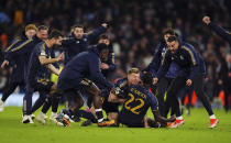 Real Madrid's Antonio Rudiger celebrates victory with teammates after winning a penalty shoot out against Manchester City following the Champions League quarterfinal, second leg soccer match at the Etihad Stadium, in Manchester, England, Wednesday, April 17, 2024. (Mike Egerton/PA via AP)