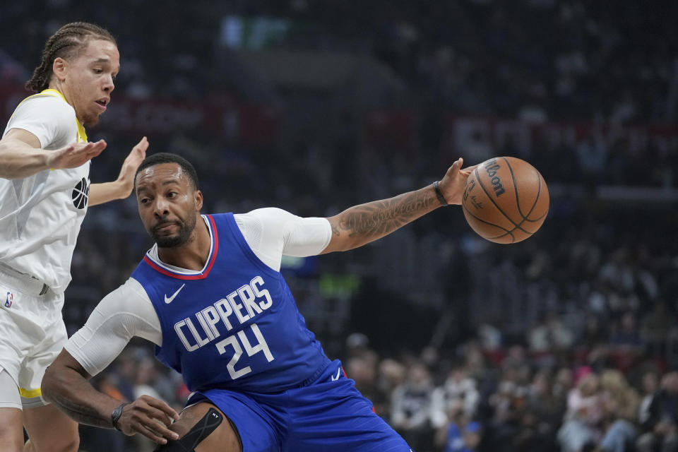 Los Angeles Clippers guard Norman Powell (24) drives against Utah Jazz guard Jason Preston (10) during the first half of an NBA basketball game in Los Angeles, Friday, April 12, 2024. (AP Photo/Eric Thayer)