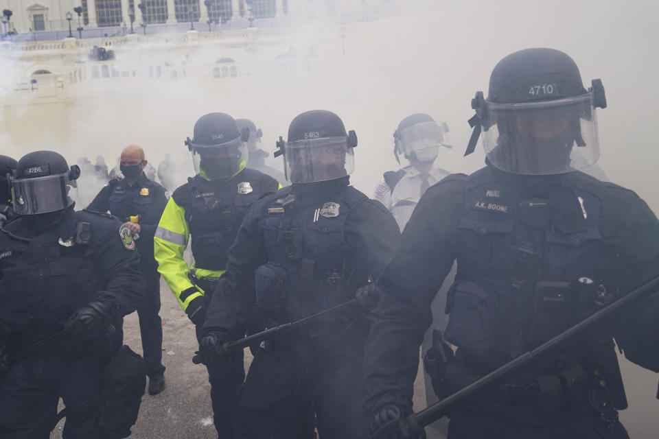 In this Wednesday, Jan. 6, 2021, photo, police form a line to try and prevent violent rioters from storming the Capitol, in Washington. The top watchdog for the U.S. Capitol Police will testify to Congress for the first time about the department’s broad failures before and during the Jan. 6 insurrection. Among them was missed intelligence and old weapons that officers didn’t feel comfortable using. (AP Photo/John Minchillo)