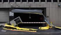 NEW YORK, NY - OCTOBER 30: A shutter is badly damaged in the aftermath of flooding following Hurricaine Sandy on October 30, 2012 in the Financial District of New York, United States. The storm has claimed at least 16 lives in the United States, and has caused massive flooding accross much of the Atlantic seaboard. US President Barack Obama has declared the situation a 'major disaster' for large areas of the US East Coast including New York City. (Photo by Andrew Burton/Getty Images)