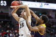 Cincinnati's Zach Harvey (23) is fouled on a shot by East Carolina's Bitumba Baruti, right, during the second half of an NCAA college basketball game, Sunday, Jan. 19, 2020, in Cincinnati. (AP Photo/John Minchillo)