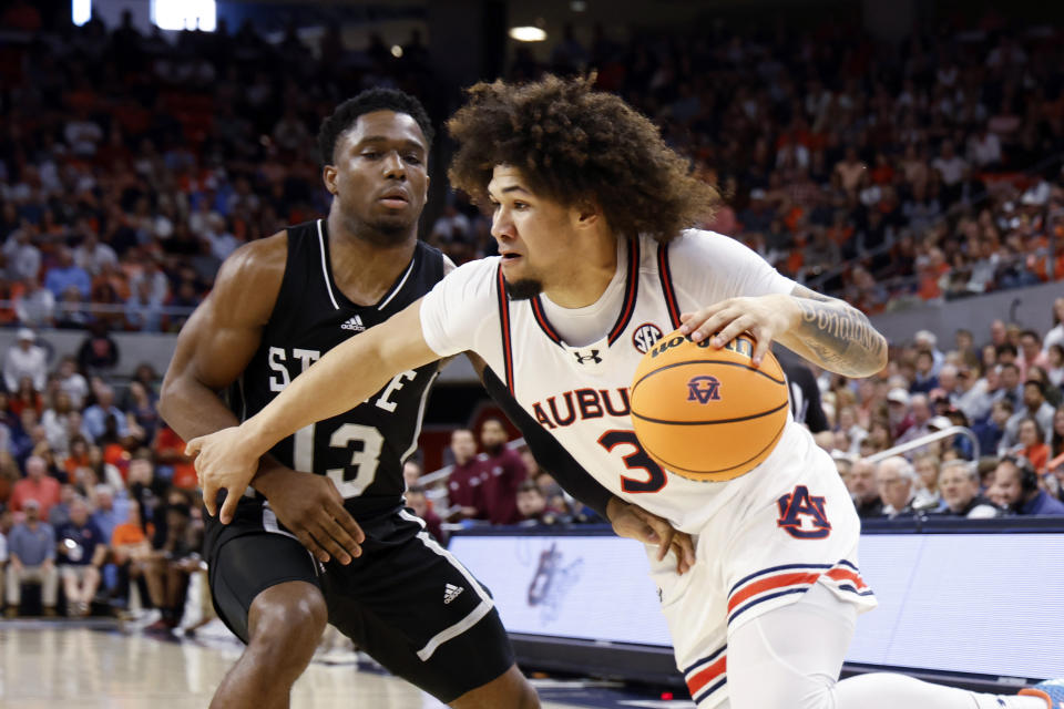 Auburn guard Tre Donaldson (3) drives around Mississippi State guard Josh Hubbard (13) during the second half of an NCAA college basketball game, Saturday, March 2, 2024, in Auburn, Ala. (AP Photo/ Butch Dill)