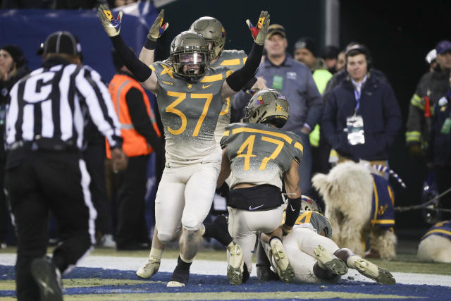 Army players celebrate after Army defensive back Noah Short (47) blocked a punt return by Navy punter Riley Riethman (90) for a touchdown in the second quarter of an NCAA college football game in Philadelphia, Saturday, Dec. 10, 2022. (Heather Khalifa/The Philadelphia Inquirer via AP)