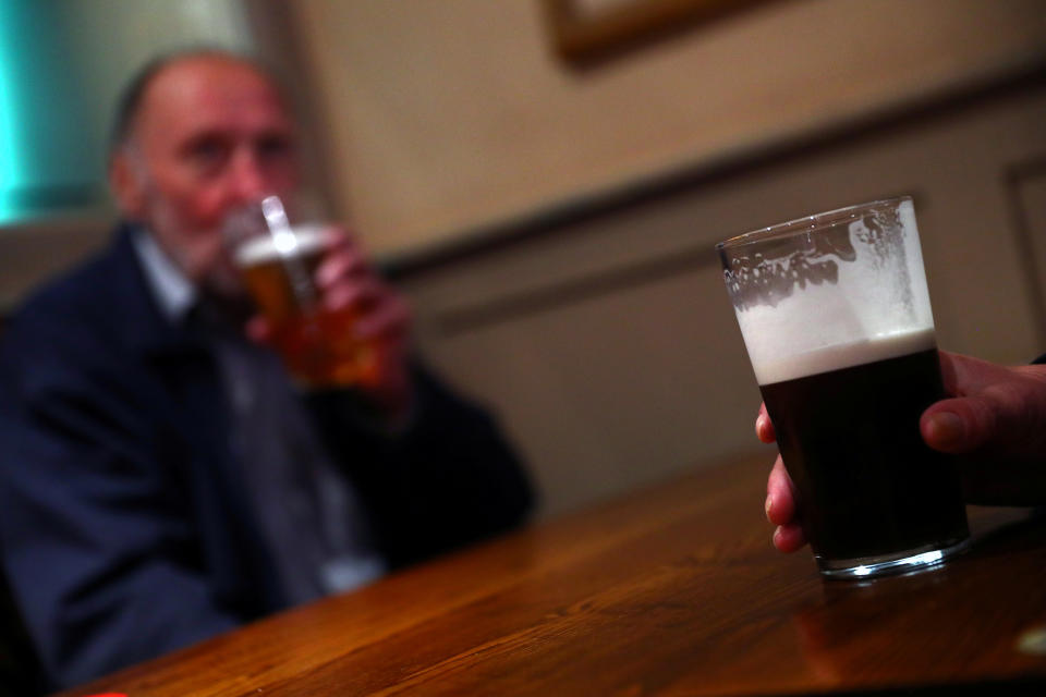 A customer holds a beer at The Holland Tringham Wetherspoons pub after it reopened following the outbreak of the coronavirus disease (COVID-19), in London, Britain July 4, 2020. REUTERS/Hannah McKay