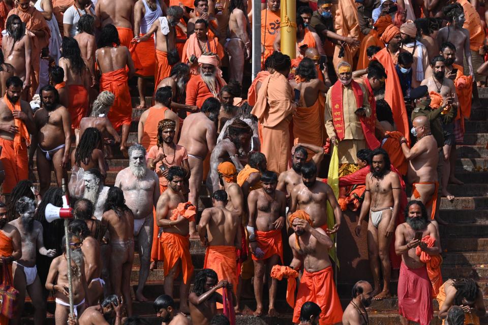 Naga Sadhus (Hindu holy men) gather to take a holy dip in the waters of the River Ganges on the Shahi snan (grand bath) on the occasion of Maha Shivratri festival during the ongoing religious Kumbh Mela festival in Haridwar on March 11, 2021. (Photo by Prakash SINGH / AFP) (Photo by PRAKASH SINGH/AFP via Getty Images)