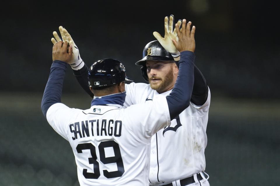 Detroit Tigers left fielder Robbie Grossman celebrates his walk-off single with first base coach Ramon Santiago (39) in the ninth inning of a baseball game against the Kansas City Royals in Detroit, Tuesday, May 11, 2021. Detroit won 8-7. (AP Photo/Paul Sancya)