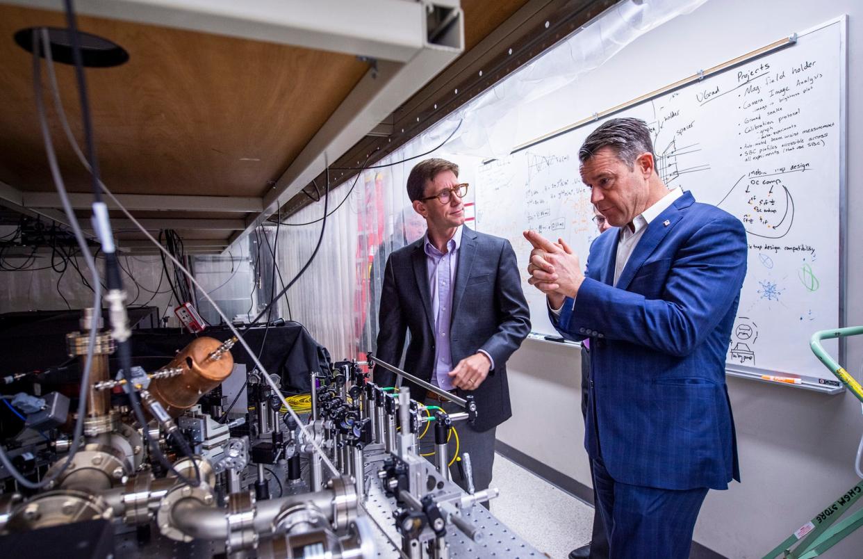 Sen. Todd Young, right, talks with Professor Phil Richerme, left, about the work done inside the quantum lab inside Simon Hall at Indiana University on Monday, May 8, 2023.