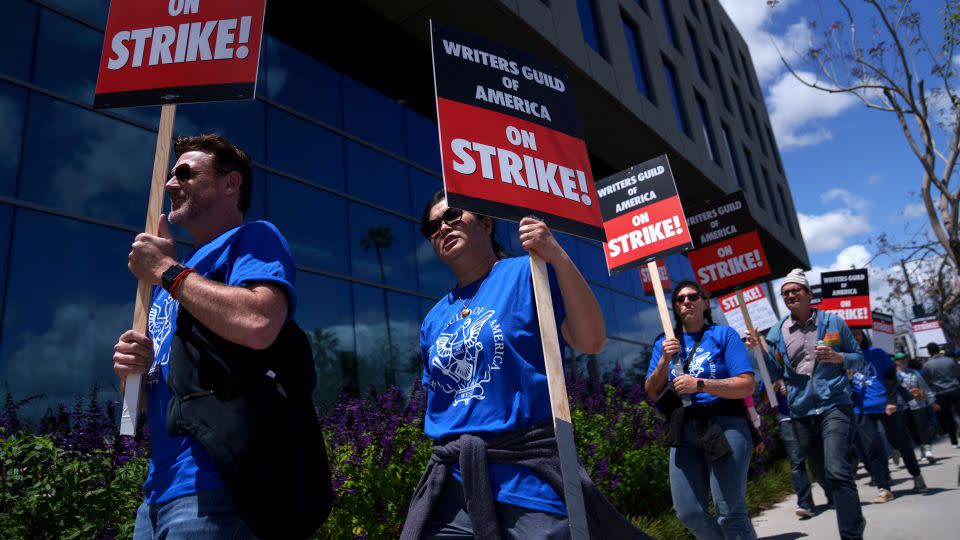 Striking Writers Guild of America workers picket outside the Sunset Bronson Studios building on May 2 in Los Angeles. - Eric Thayer/Getty Images