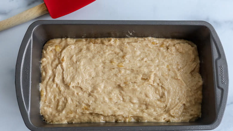 Banana bread batter spread into a pan