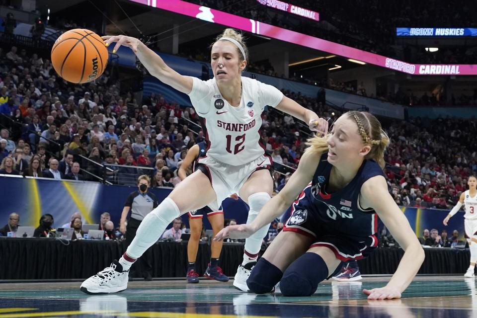 Stanford's Lexie Hull and UConn's Paige Bueckers go after a loose ball during the first half of a college basketball game in the semifinal round of the Women's Final Four NCAA tournament Friday, April 1, 2022, in Minneapolis. (AP Photo/Eric Gay)