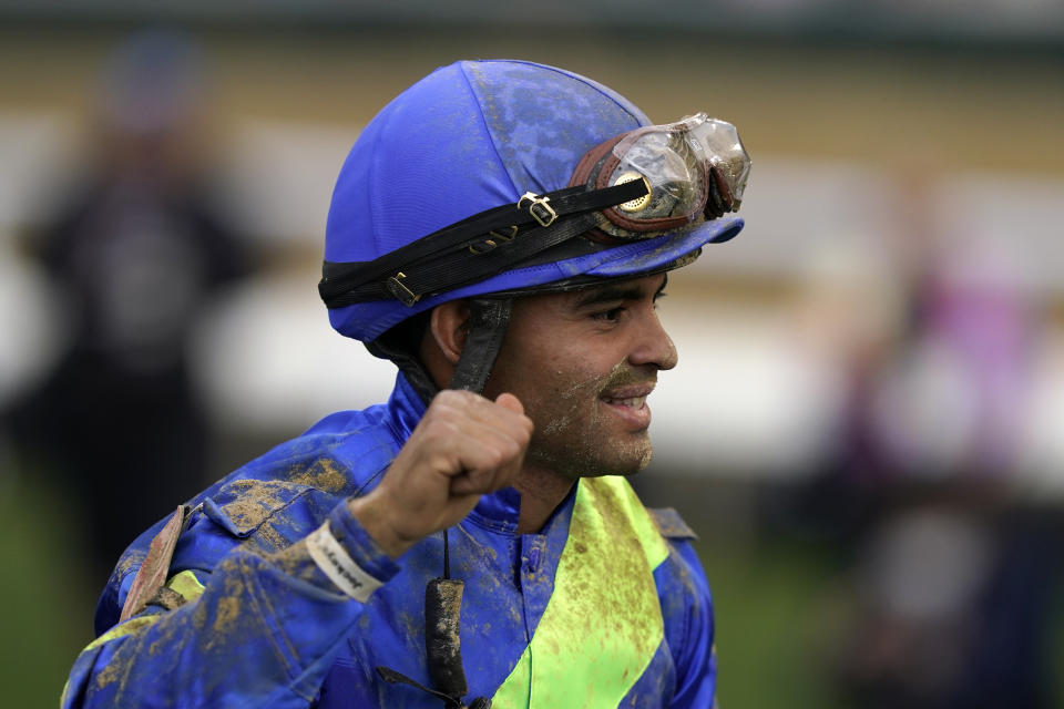 Luis Saez celebrates after riding Secret Oath to victory in the 148th running of the Kentucky Oaks horse race at Churchill Downs Friday, May 6, 2022, in Louisville, Ky. (AP Photo/Brynn Anderson)