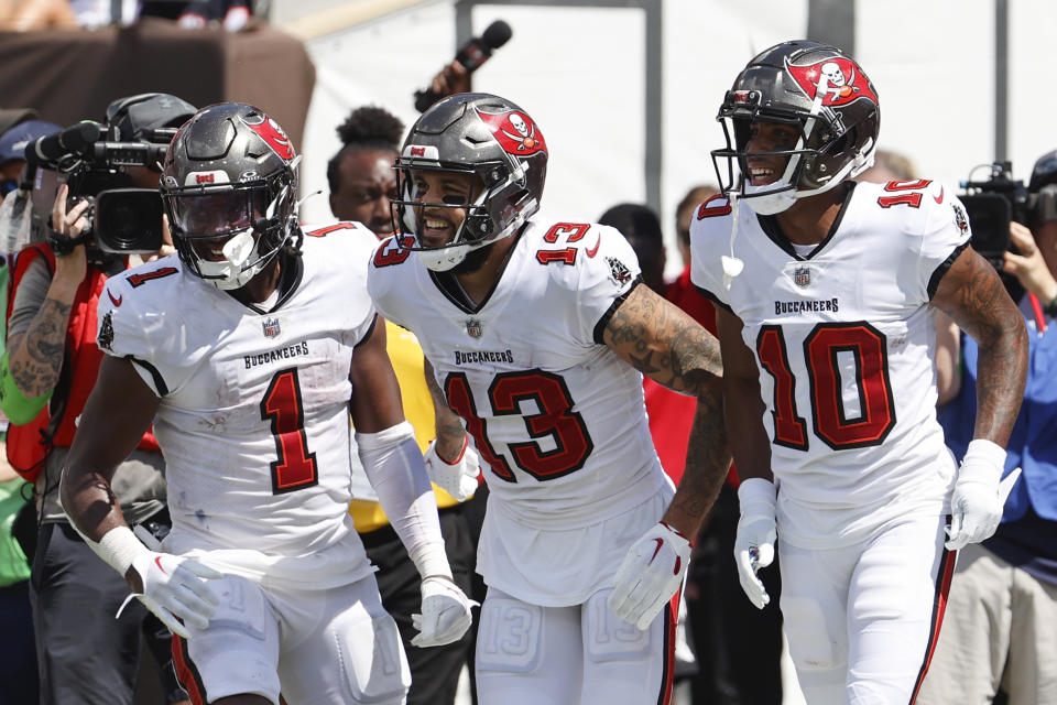 Tampa Bay Buccaneers wide receiver Mike Evans (13) celebrates with teammates running back Rachaad White (1) and wide receiver Trey Palmer (10) after scoring during the second half of an NFL football game against the Chicago Bears, Sunday, Sept. 17, 2023, in Tampa, Fla. (AP Photo/Scott Audette)