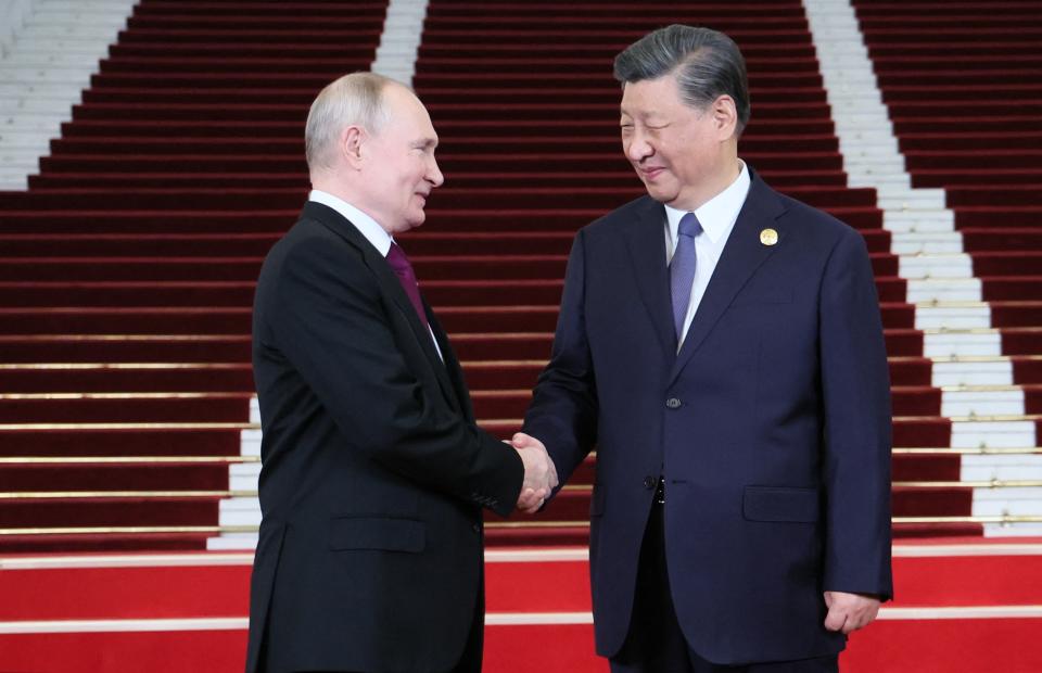 This pool photograph distributed by Russian state owned agency Sputnik shows Russia's President Vladimir Putin and Chinese President Xi Jinping shaking hands during a welcoming ceremony at the Third Belt and Road Forum in Beijing on October 17, 2023. (Photo by Sergei SAVOSTYANOV / POOL / AFP) (Photo by SERGEI SAVOSTYANOV/POOL/AFP via Getty Images)