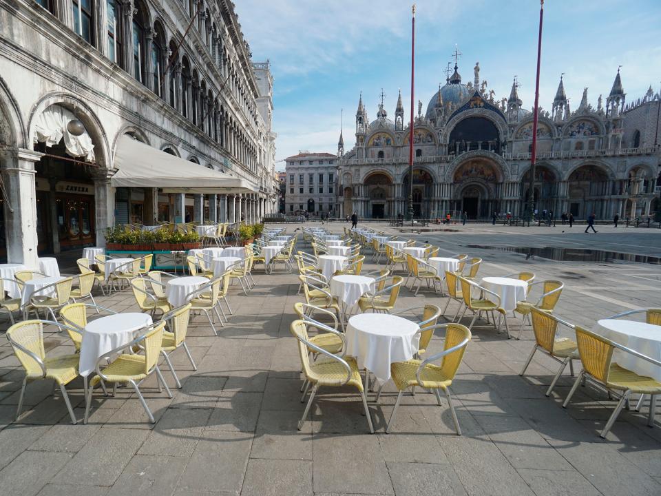 Empty chairs and tables are lined up outside a restaurant in St. Mark's Square in Venice, Italy, Monday, March 9, 2020. Italy took a page from China’s playbook Sunday, attempting to lock down 16 million people — more than a quarter of its population — for nearly a month to halt the relentless march of the new coronavirus across Europe. Italian Premier Giuseppe Conte signed a quarantine decree early Sunday for the country’s prosperous north. Areas under lockdown include Milan, Italy’s financial hub and the main city in Lombardy, and Venice, the main city in the neighboring Veneto region. (Anteo Marinoni/LaPresse via AP)