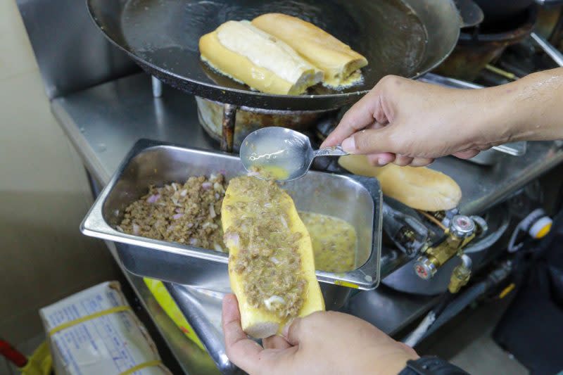 roti john - speading filling on bread