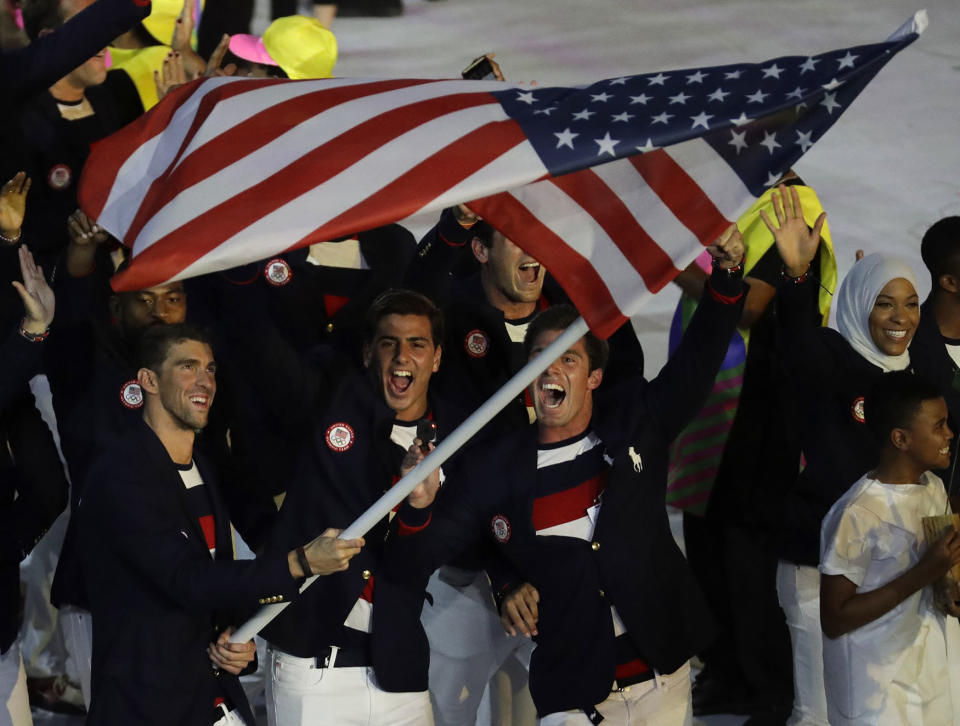 Michael Phelps carries the U.S. flag