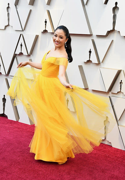 Constance Wu poses in a gauzy, bold gown